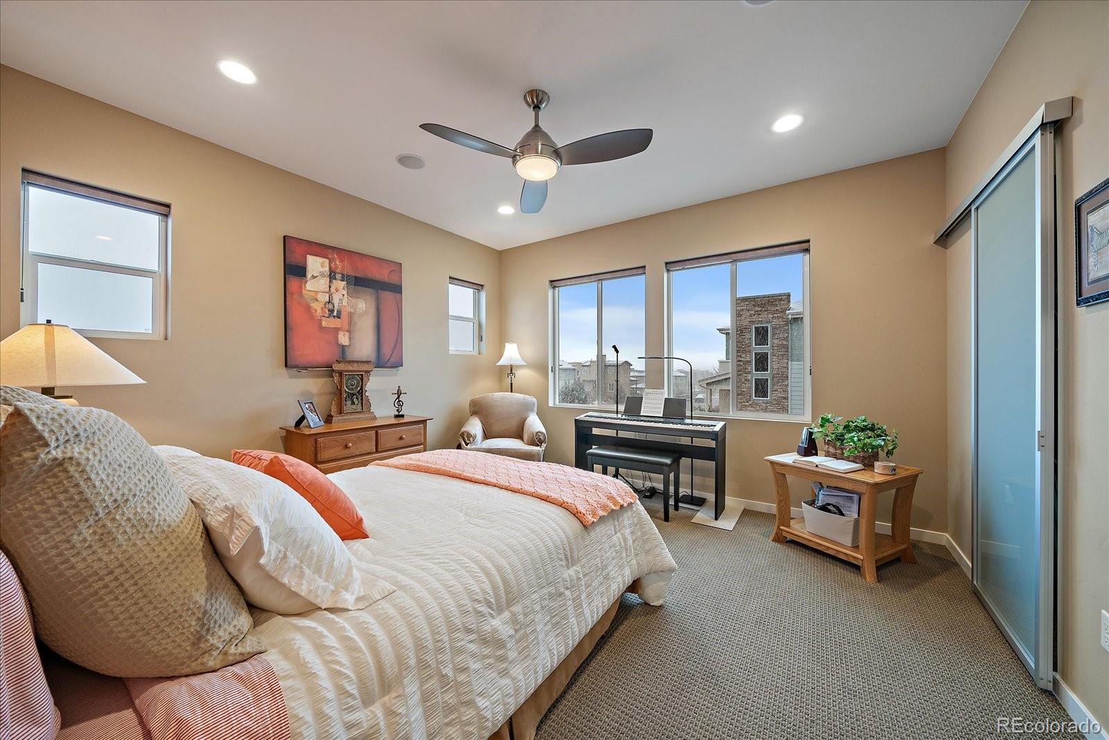 9717 Dunning Circle Highlands Ranch, CO 80126 - Photo 16 of 38 a bedroom with a bed and a chair