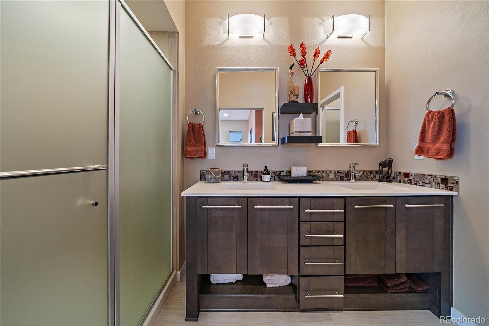 9717 Dunning Circle Highlands Ranch, CO 80126 - Photo 18 of 38 a bathroom with a sink vanity and mirror