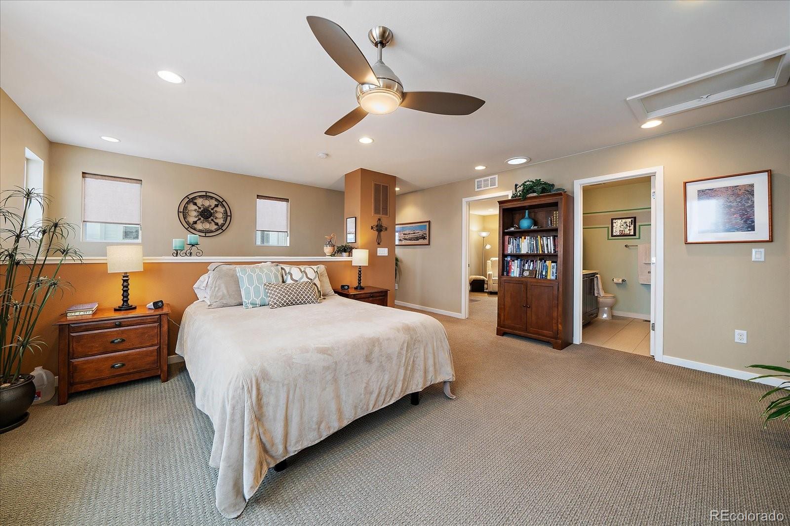 9717 Dunning Circle Highlands Ranch, CO 80126 - Photo 24 of 38 a spacious bedroom with a bed and a couch
