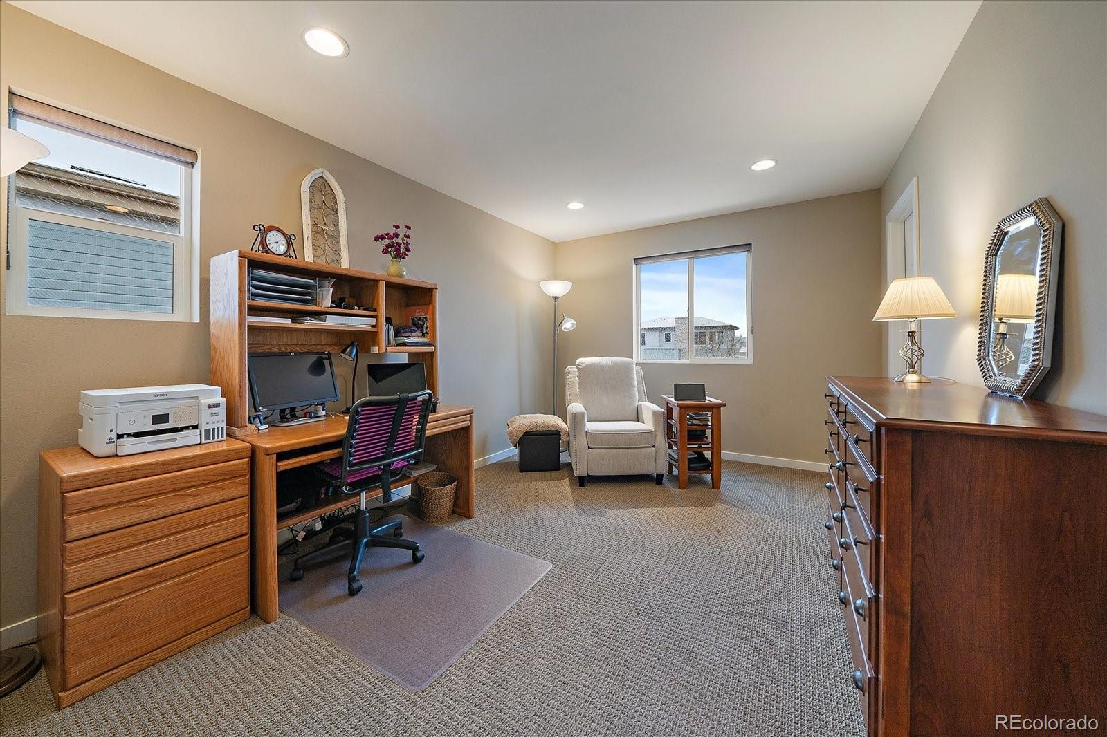 9717 Dunning Circle Highlands Ranch, CO 80126 - Photo 28 of 38 a room with furniture a desk and a flat screen tv