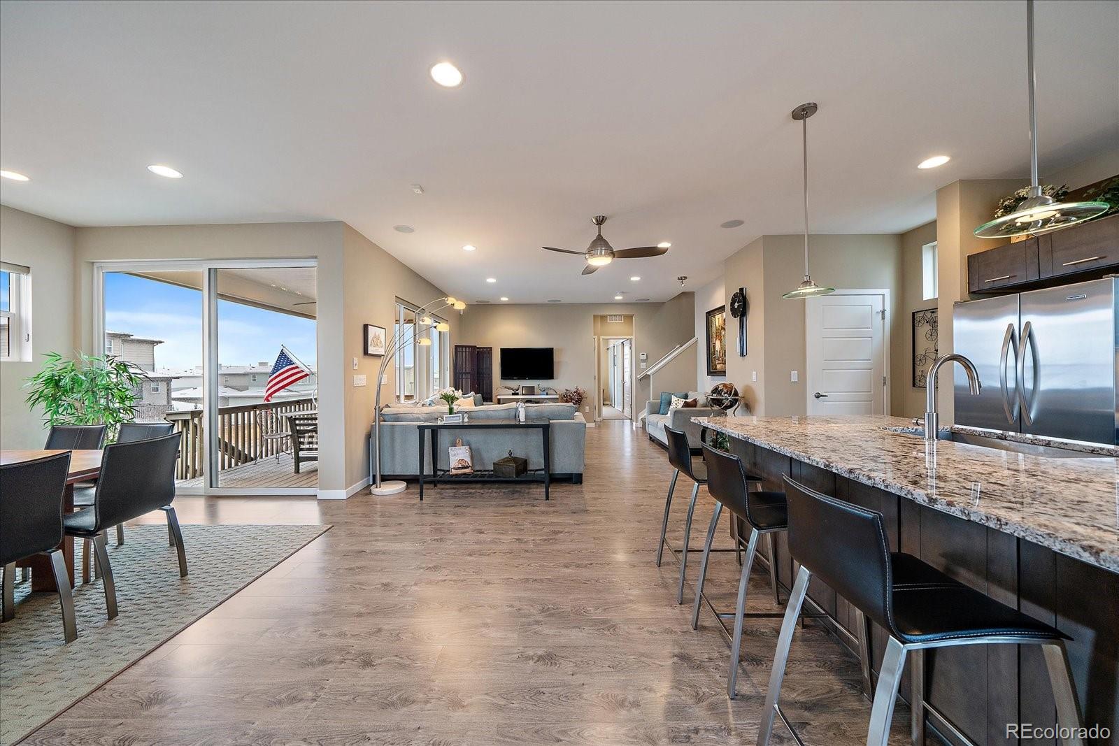 9717 Dunning Circle Highlands Ranch, CO 80126 - Photo 5 of 38 a large kitchen with a table and chairs in it