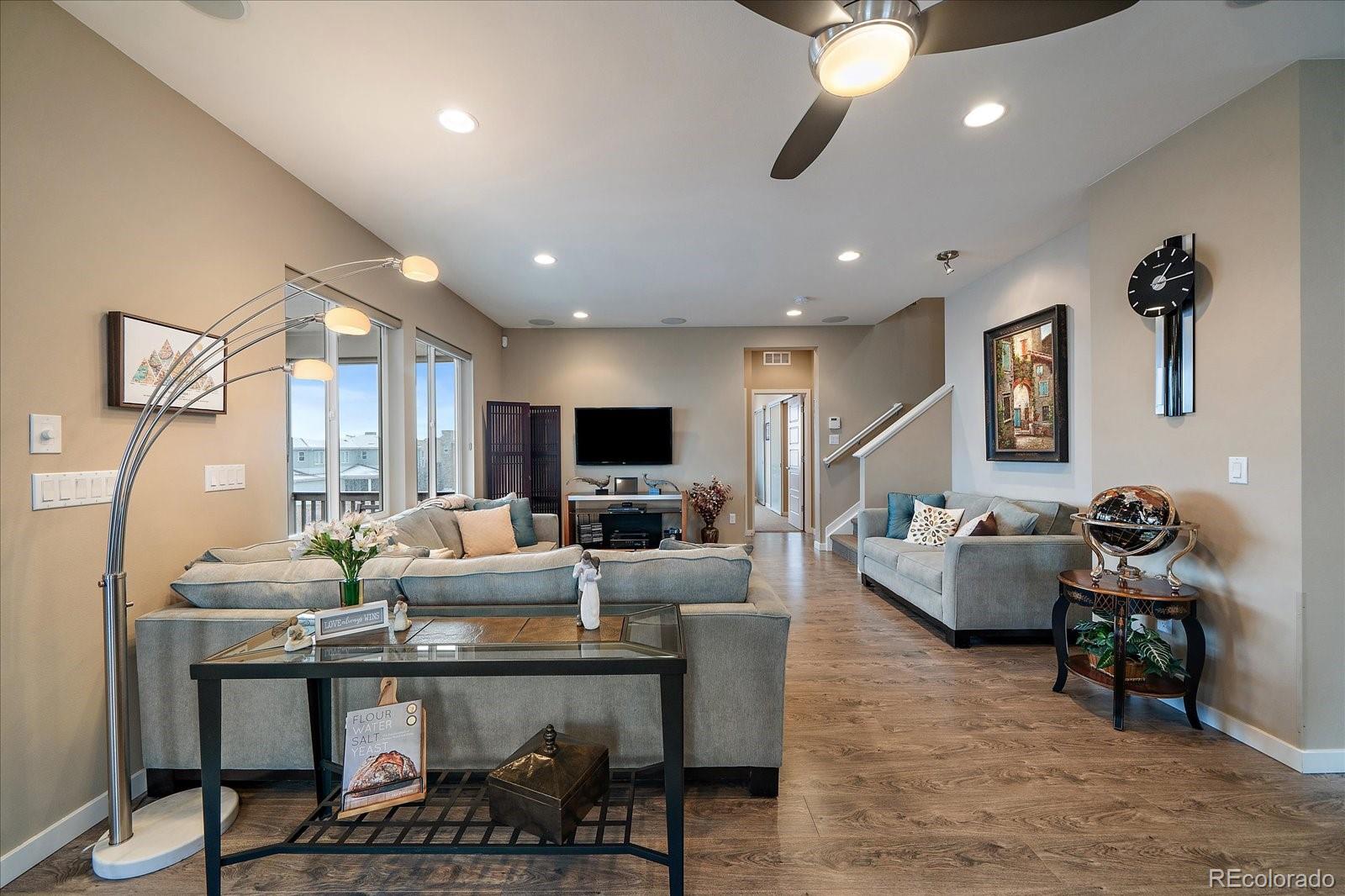 9717 Dunning Circle Highlands Ranch, CO 80126 - Photo 6 of 38 a living room with fireplace furniture and a flat screen tv