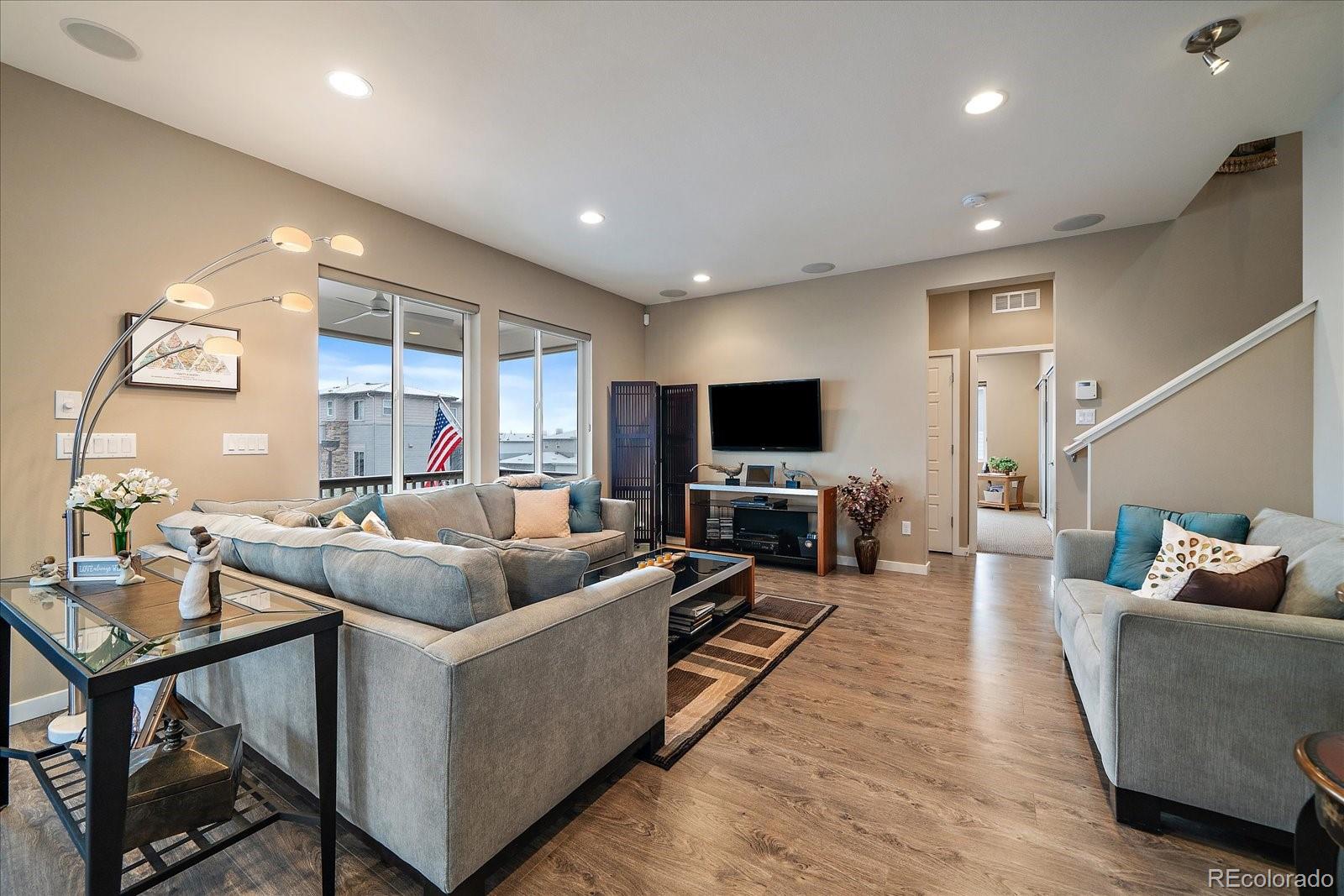 9717 Dunning Circle Highlands Ranch, CO 80126 - Photo 7 of 38 a living room with furniture and a flat screen tv