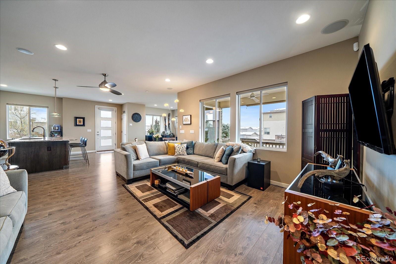 9717 Dunning Circle Highlands Ranch, CO 80126 - Photo 8 of 38 a living room with furniture flat screen tv and a large window