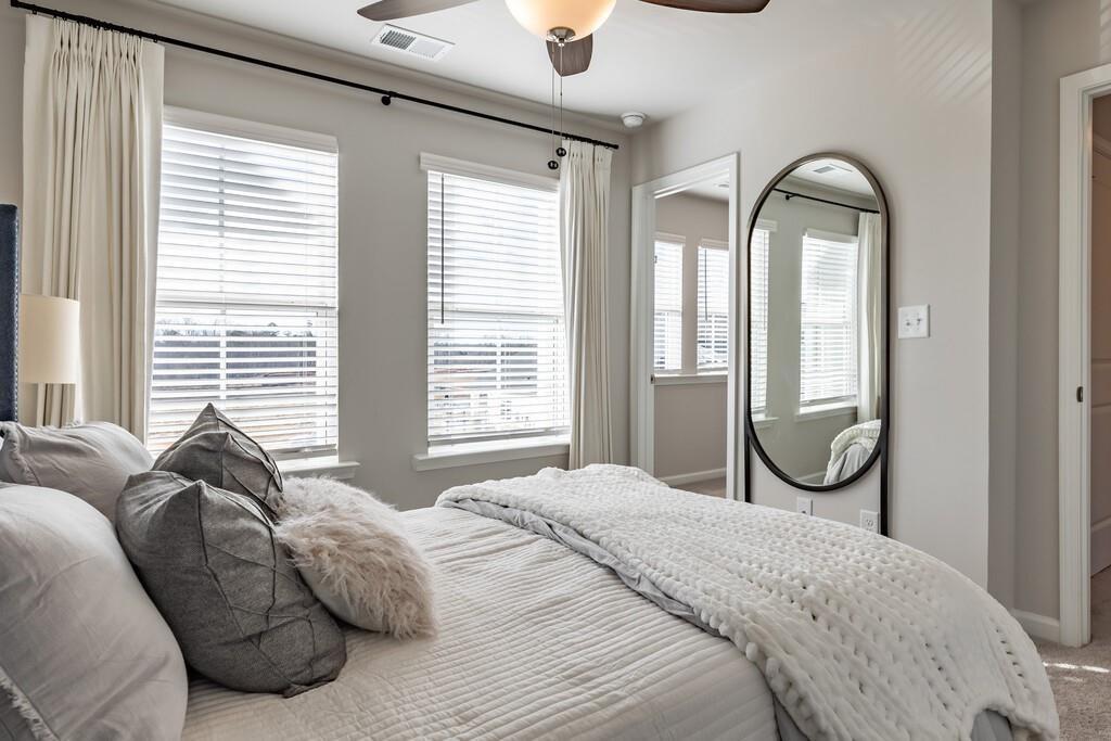 513 Kirkland Road, Unit CARRAWAY Covington, GA 30016 - Photo 13 of 53 a spacious bedroom with a bed and glass windows
