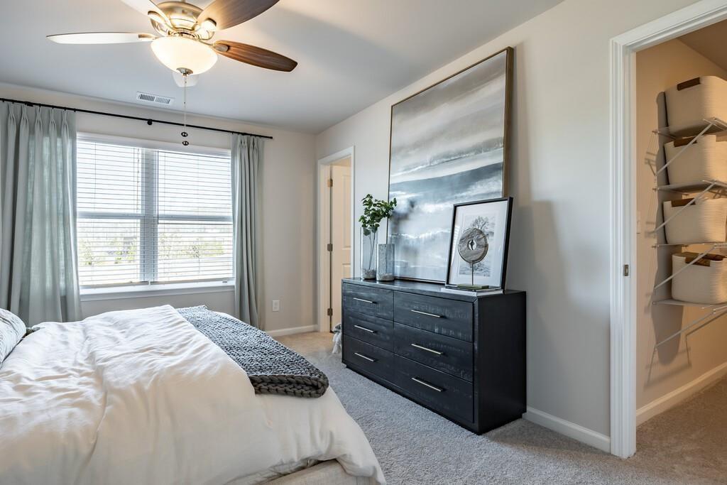 513 Kirkland Road, Unit CARRAWAY Covington, GA 30016 - Photo 16 of 53 a bedroom with a bed and a chandelier