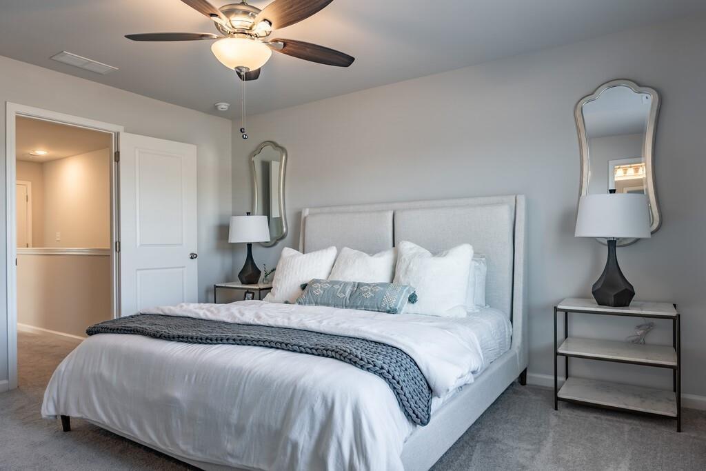 513 Kirkland Road, Unit CARRAWAY Covington, GA 30016 - Photo 17 of 53 a bedroom with a bed and a chandelier