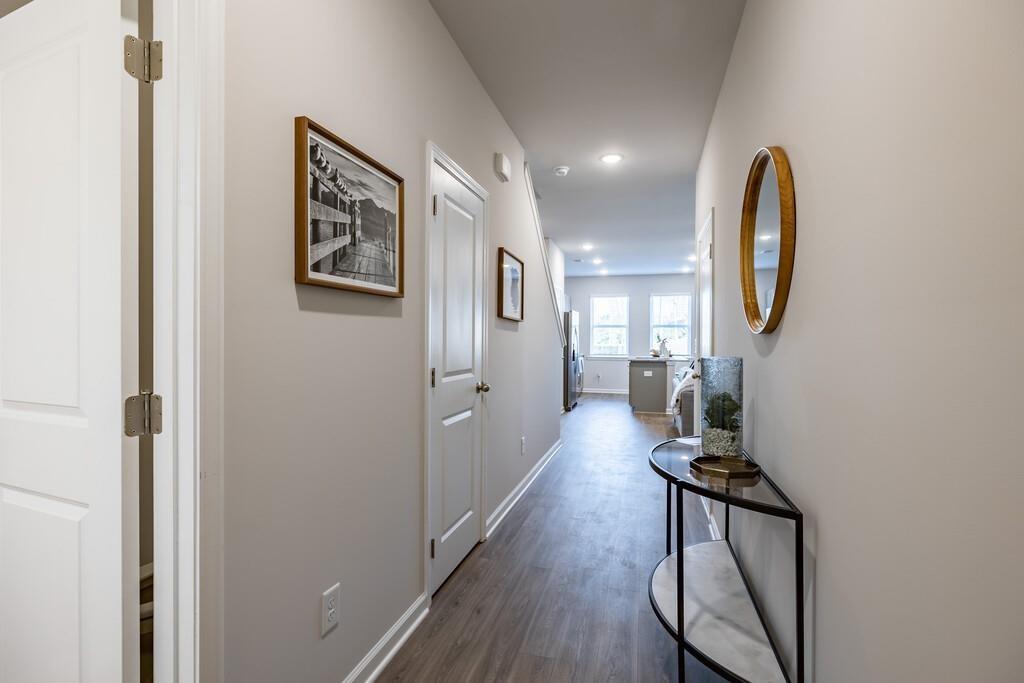 513 Kirkland Road, Unit CARRAWAY Covington, GA 30016 - Photo 3 of 53 a view of a hallway with wooden floor and workspace