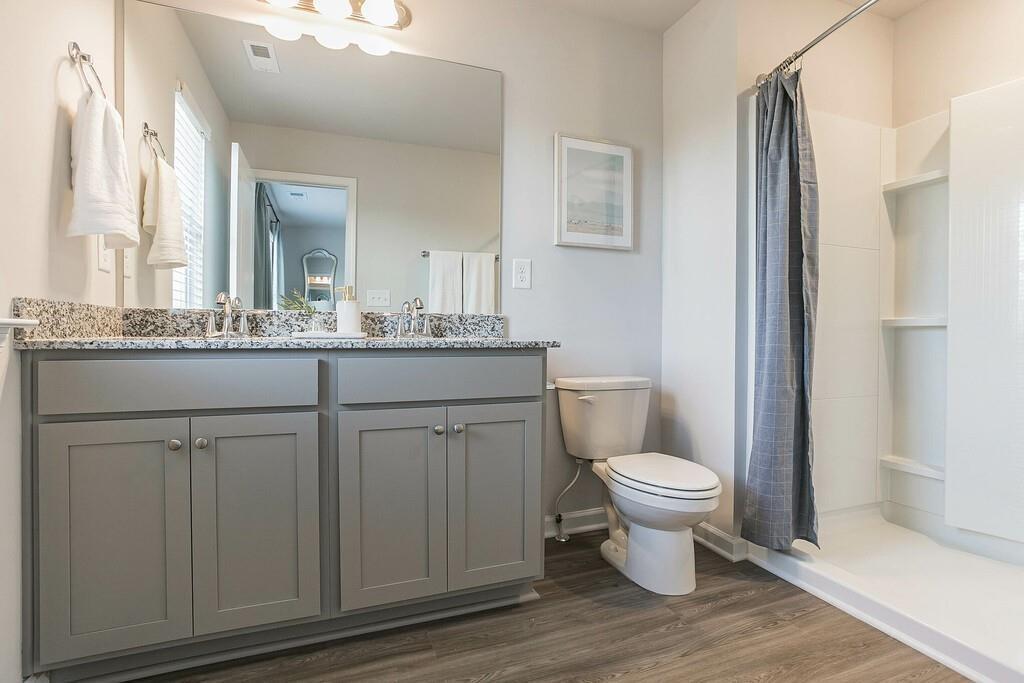 513 Kirkland Road, Unit CARRAWAY Covington, GA 30016 - Photo 37 of 53 a bathroom with a toilet sink and mirror