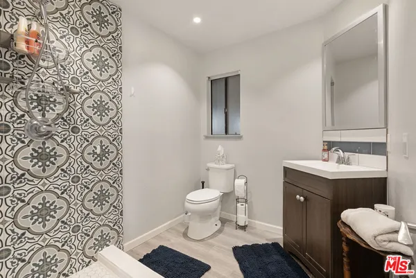 a bathroom with a sink toilet and a mirror