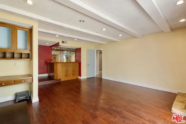 a view of a livingroom with wooden floor and furniture