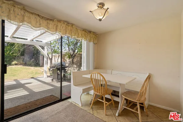 a view of a dining room with furniture wooden floor and chandelier