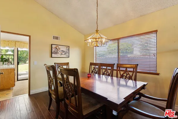 a dining room with furniture window and wooden floor