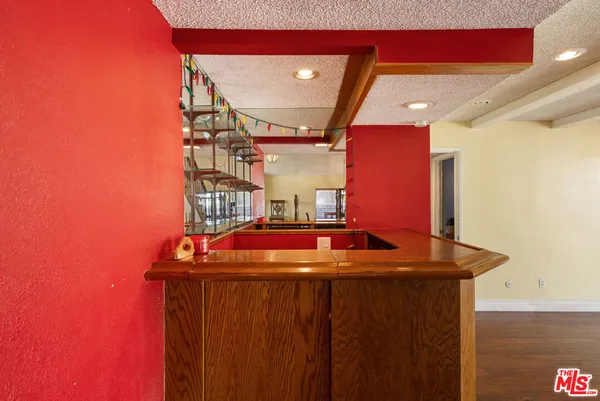 a room with red door and wooden floor