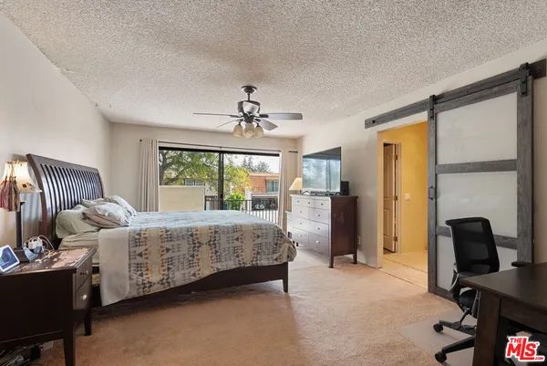 a bathroom with a double vanity sink a mirror and a toilet