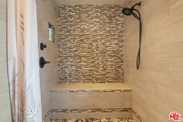 a bedroom with a bed table and a window