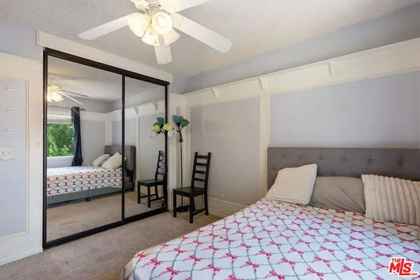 a bedroom with bed and window