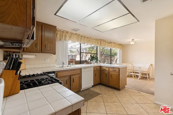 a kitchen with a sink a stove a washer and dryer