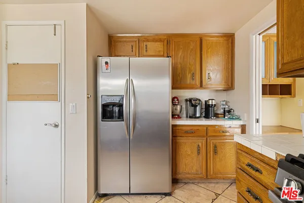 a kitchen with stainless steel appliances granite countertop a refrigerator and a stove