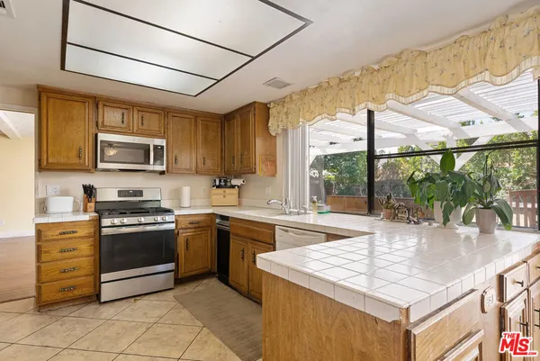 a kitchen with stainless steel appliances granite countertop a stove and a sink