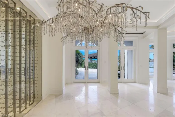 a view of a big room with windows and chandelier