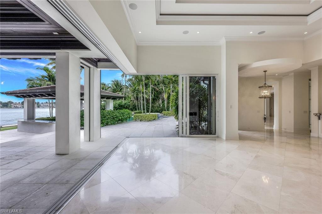 970 Aqua Circle Naples, FL 34102 - Photo 20 of 43 a view of a hallway with wooden floor and a living room