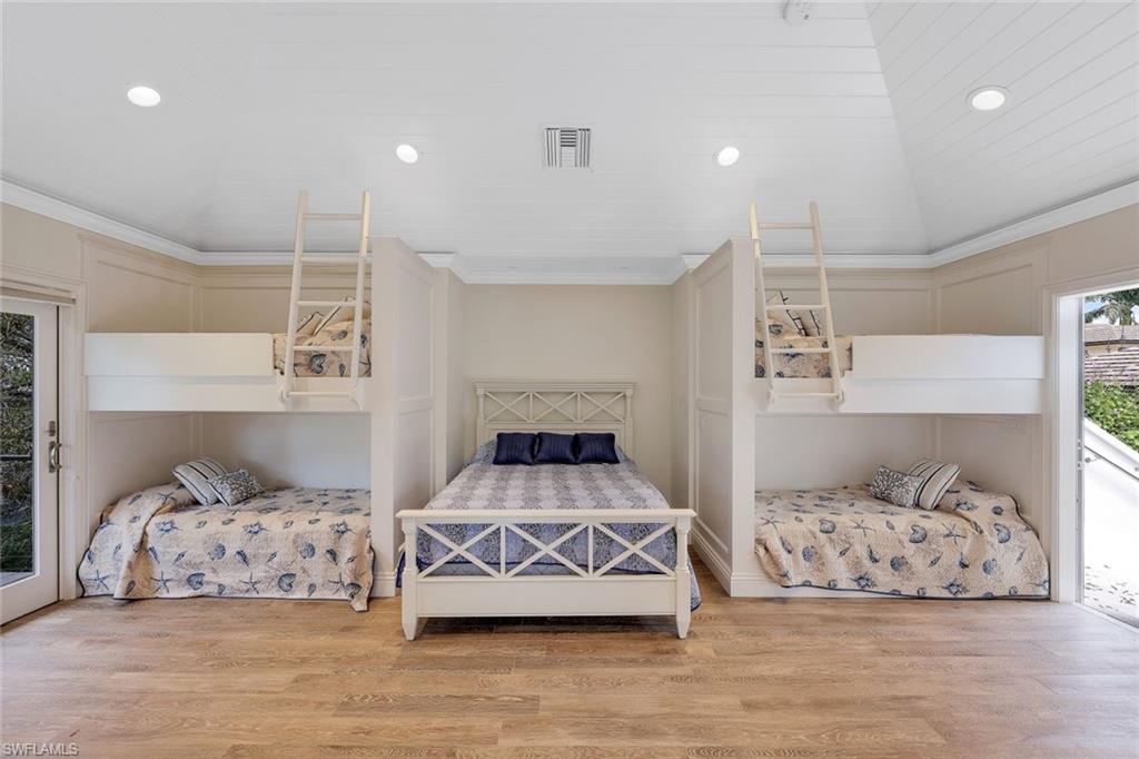 970 Aqua Circle Naples, FL 34102 - Photo 36 of 43 a bedroom with a large bed and a couch