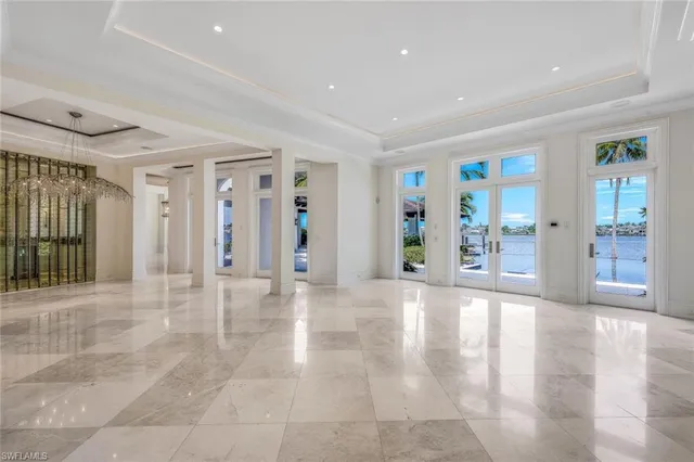 a view of an entryway with wooden floor and a livingroom