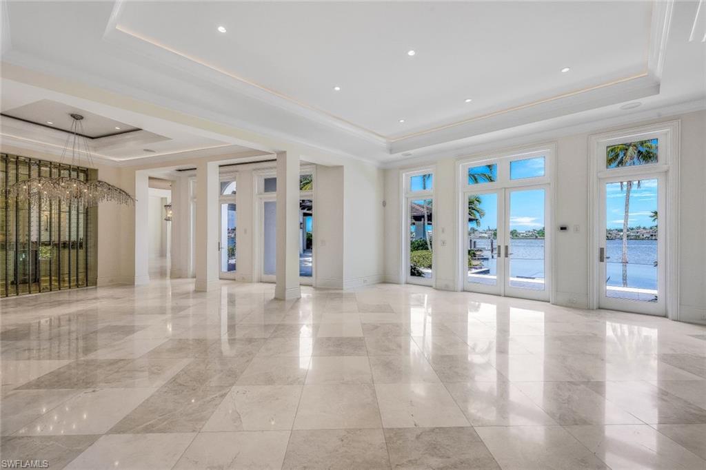 970 Aqua Circle Naples, FL 34102 - Photo 6 of 43 a view of an entryway with wooden floor and a livingroom