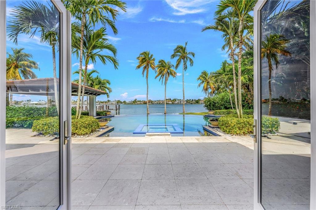 970 Aqua Circle Naples, FL 34102 - Photo 8 of 43 a view of a patio with a tree