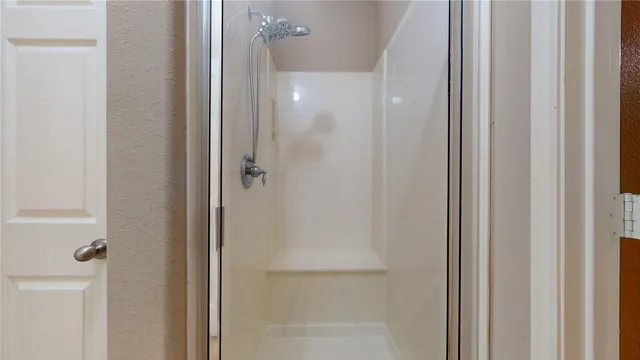 a spacious bathroom with a granite countertop sink and a mirror