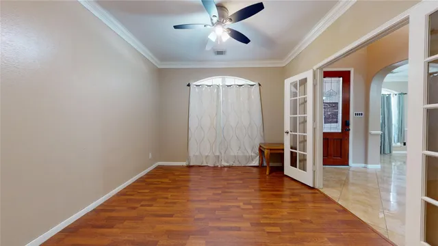 a view of empty room with wooden floor