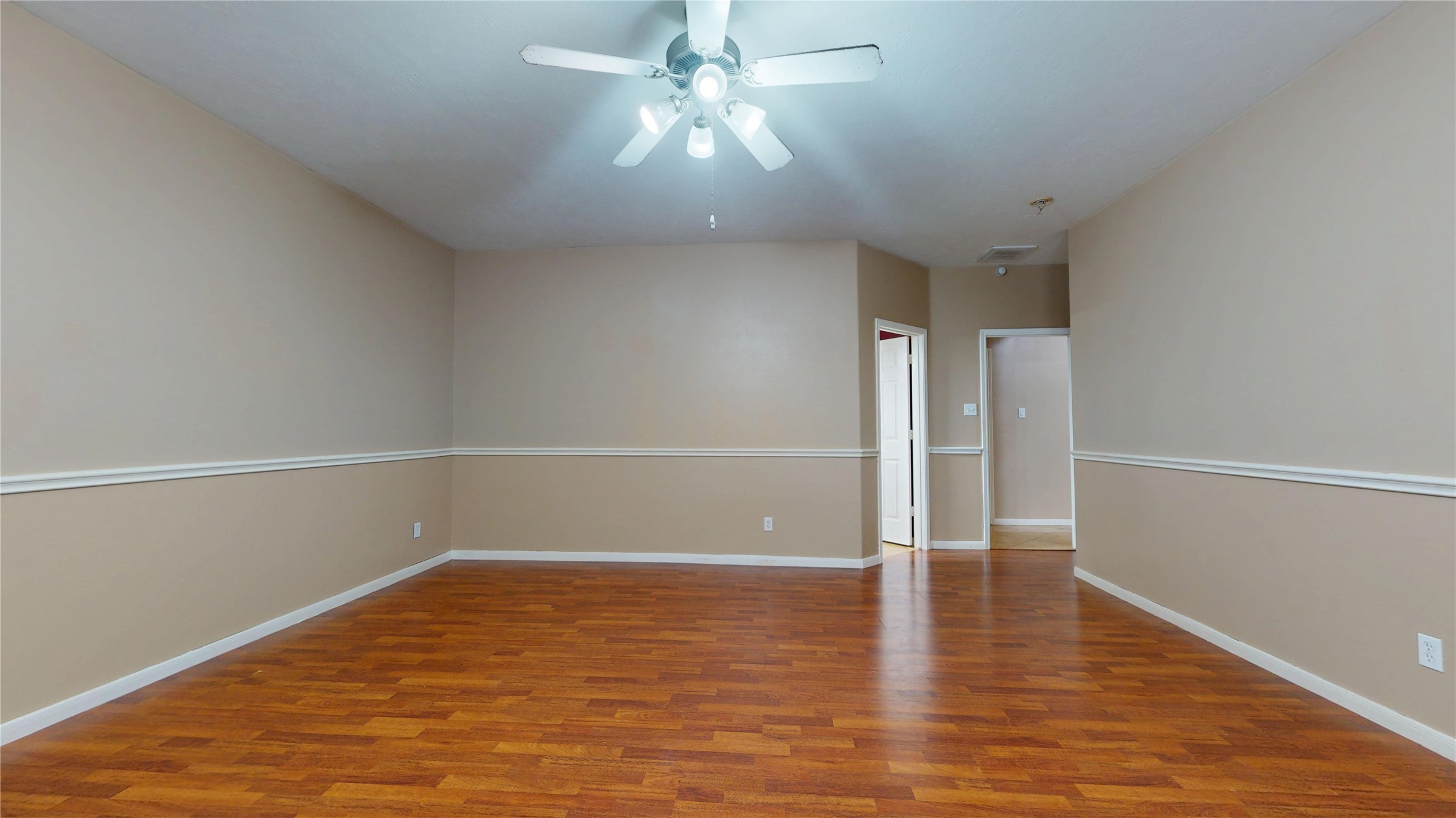 21050 Florette Lane Spring, TX 77388 - Photo 21 of 50 a view of a room with wooden floor and a ceiling fan