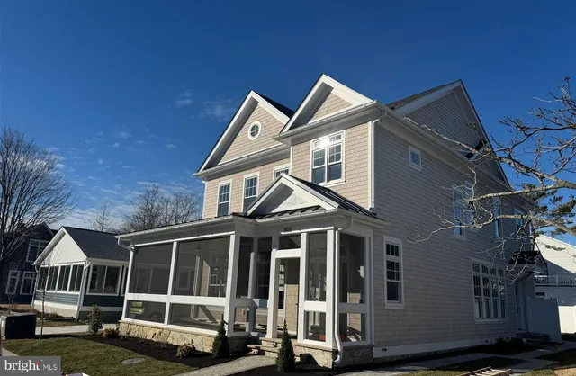 a view of a house with wooden fence