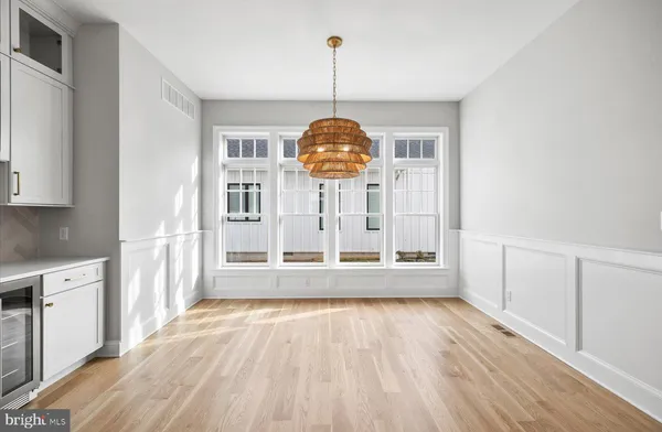 a view of a room with wooden floor fan and window