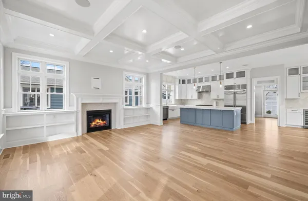 a view of an empty room with a fireplace and a window