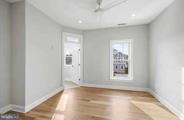 an empty room with windows and closet