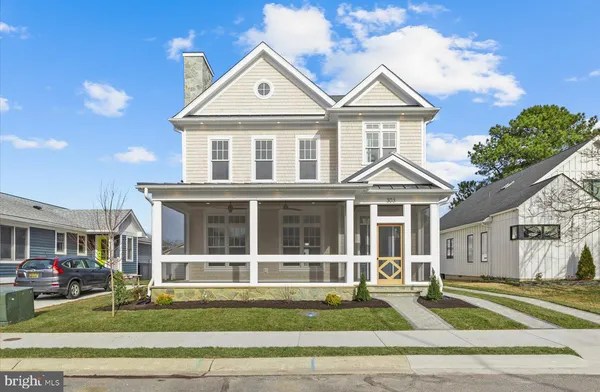 a front view of a residential houses with yard