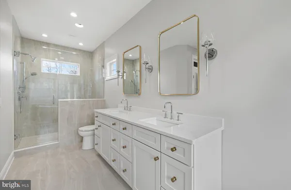 a bathroom with a double vanity sink mirror and double
