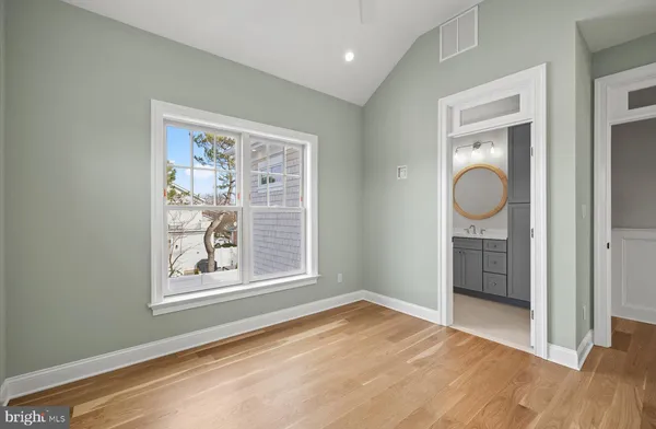 an empty room with windows and closet