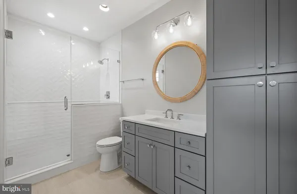 a bathroom with a toilet a sink and a mirror