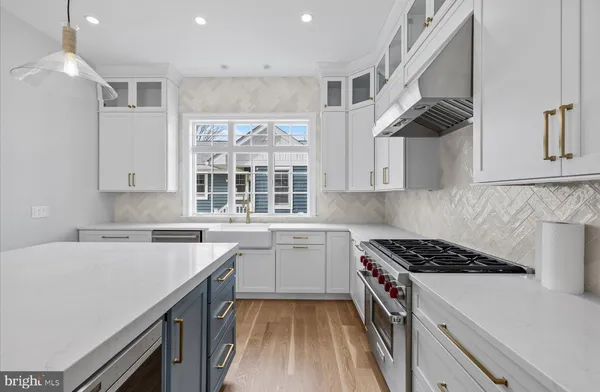 a kitchen with cabinets appliances a sink and a window