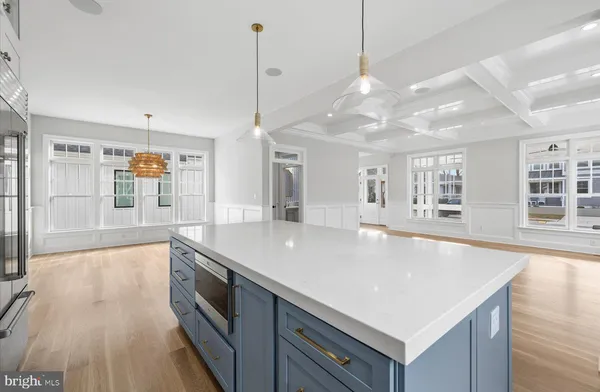 a kitchen with stainless steel appliances granite countertop a sink a oven a counter space and a center island