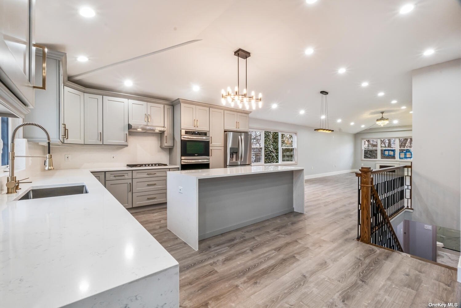 a kitchen with stainless steel appliances kitchen island wooden cabinets and a refrigerator