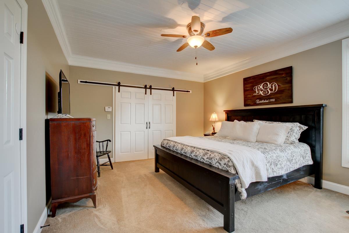 730 Dixie Bee Road Clarksville, TN 37043 - Photo 15 of 30 a bedroom with a bed and a chandelier