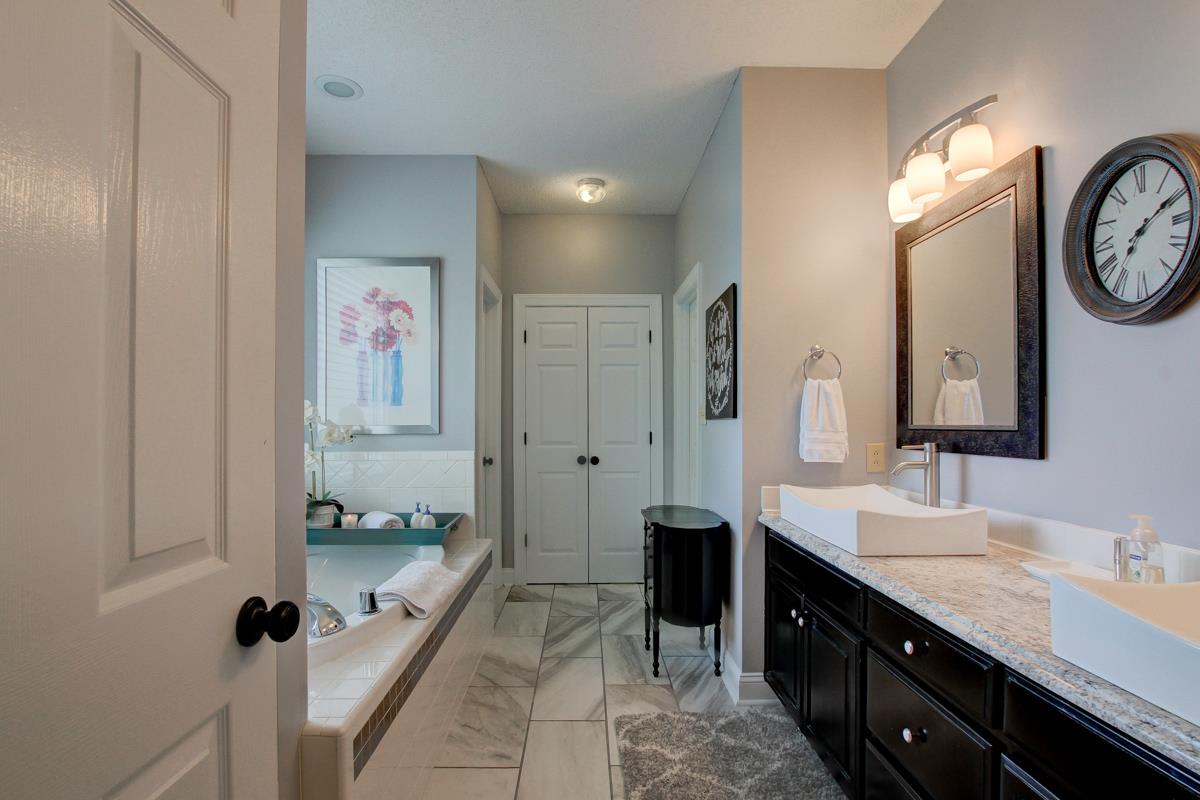 730 Dixie Bee Road Clarksville, TN 37043 - Photo 16 of 30 a spacious bathroom with a granite countertop sink and a mirror