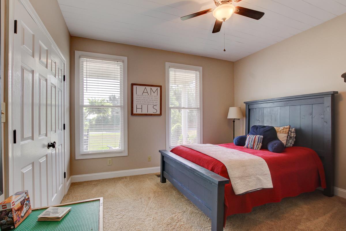 730 Dixie Bee Road Clarksville, TN 37043 - Photo 18 of 30 a bedroom with a bed and a chandelier