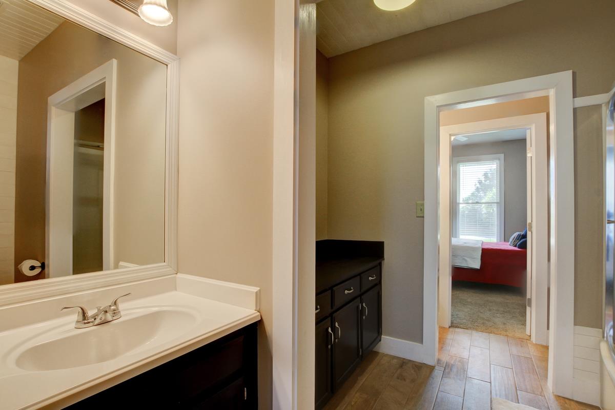 730 Dixie Bee Road Clarksville, TN 37043 - Photo 20 of 30 a en suite bathroom with a sink and a mirror