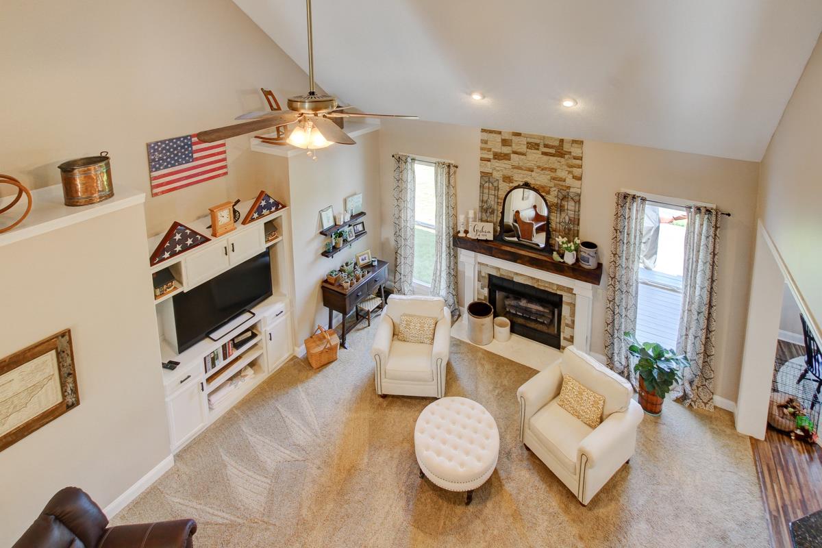 730 Dixie Bee Road Clarksville, TN 37043 - Photo 25 of 30 a living room with furniture flat screen tv and a fireplace