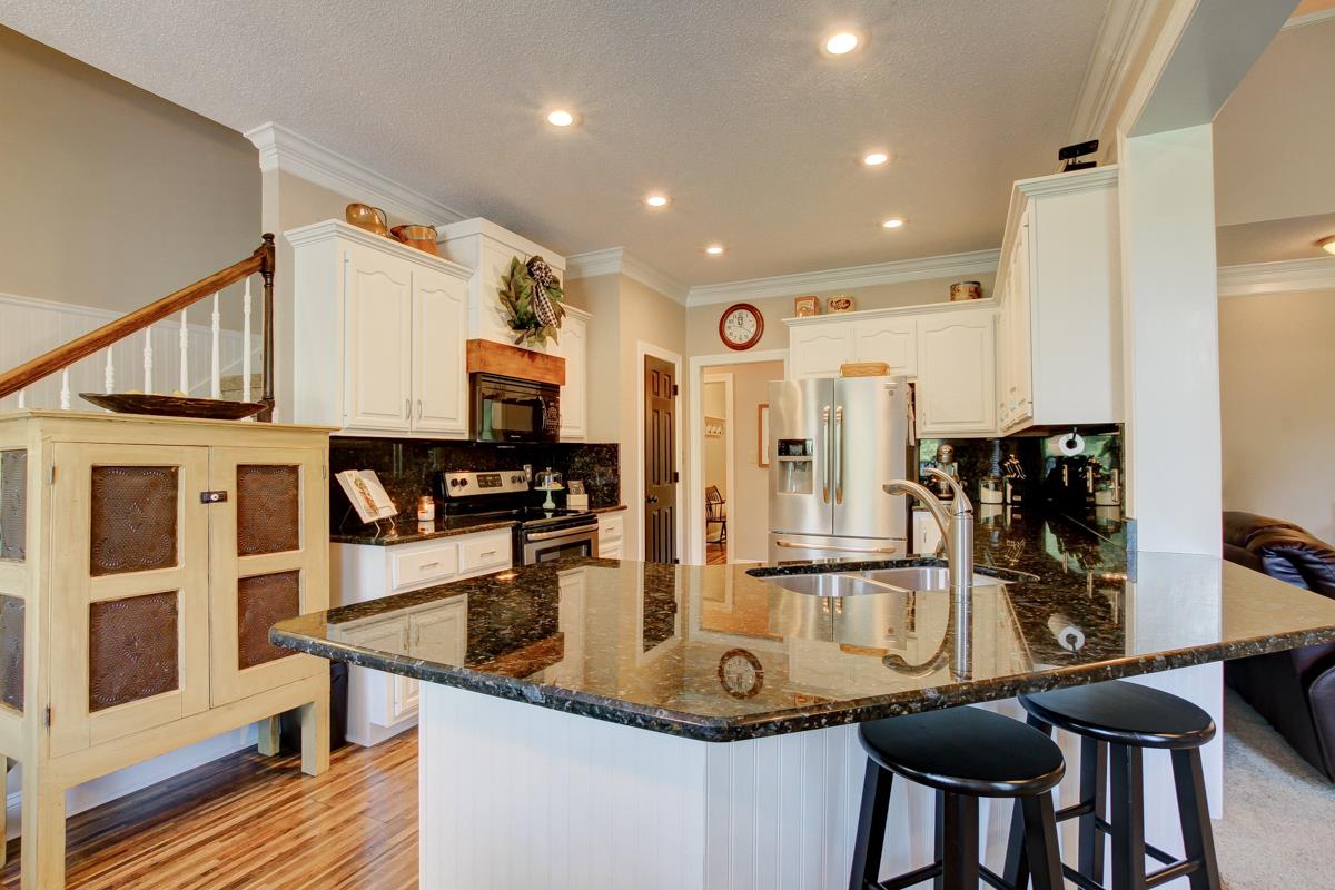 730 Dixie Bee Road Clarksville, TN 37043 - Photo 8 of 30 a kitchen with stainless steel appliances granite countertop a dining table chairs and stove